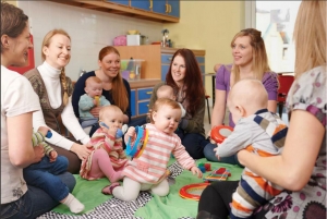 a group of moms and babies form a babysitting circle
