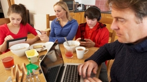 Family looking at devices not unplugged