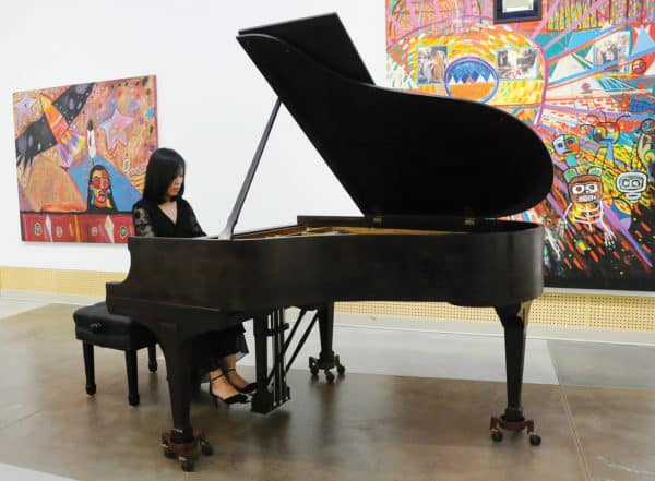 Lixia Li plays the 100-year-old Steinway & Sons baby grand piano gifted to the Gordon & Marion Smith Foundation by Kathryn Allison. Photo by Cindy Goodman.