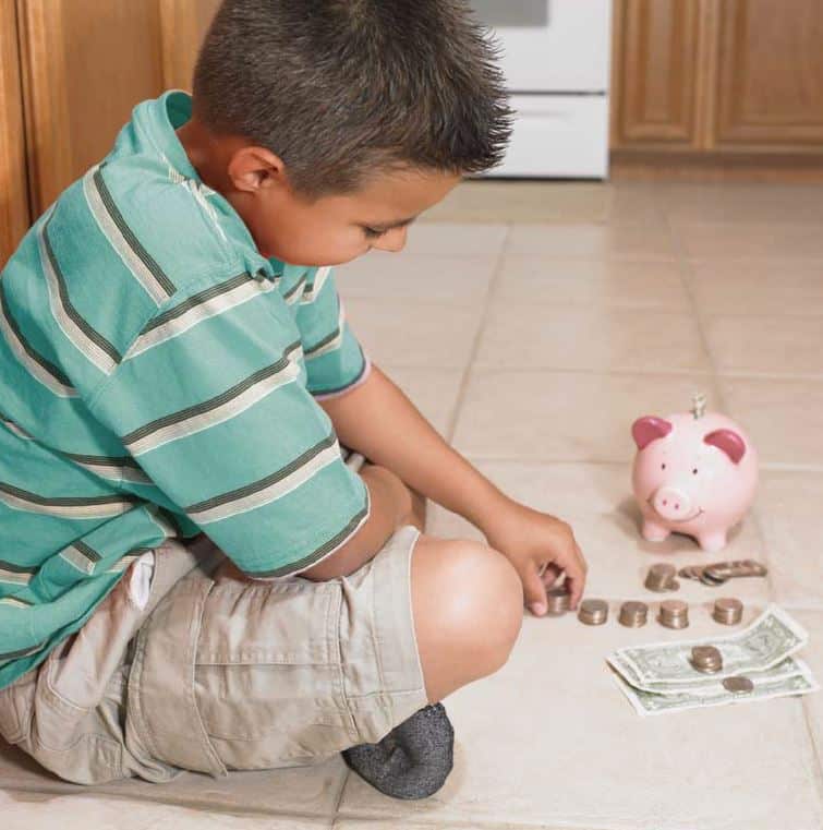 a young boy counting his savings money