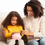 Mummy and daughter engaging on money lessons