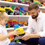 Boy and Dad in the toystore looking for gifts 4-6 year old.