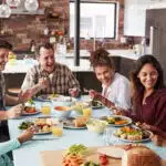 A family enjoying a meal together, adults and kids. Healthy meals for kids.