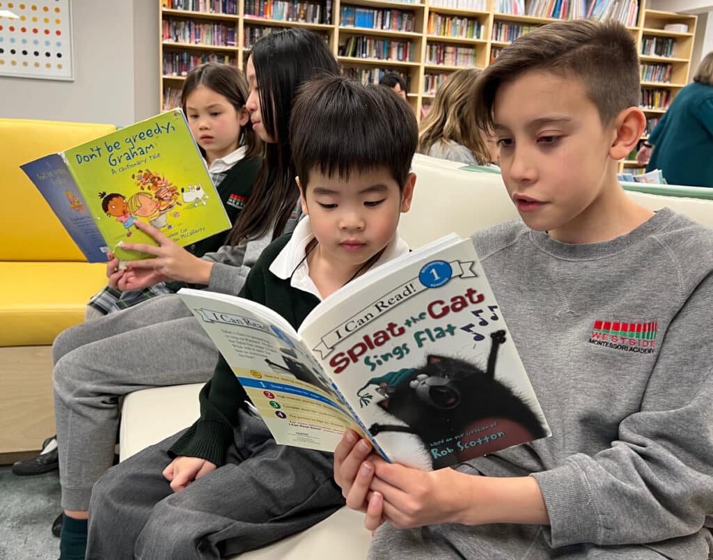 Reading Buddies in library at Westside Montessori Academy