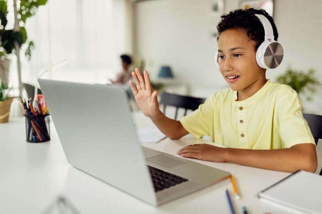 child with computer enjoying technology
