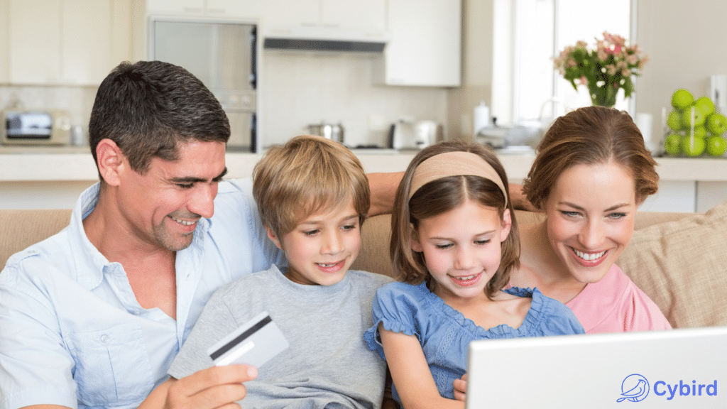 Mom, Dad, and son and daughter smiling as they are looking at computer screen with Cybird logo on the cover of the computer. 