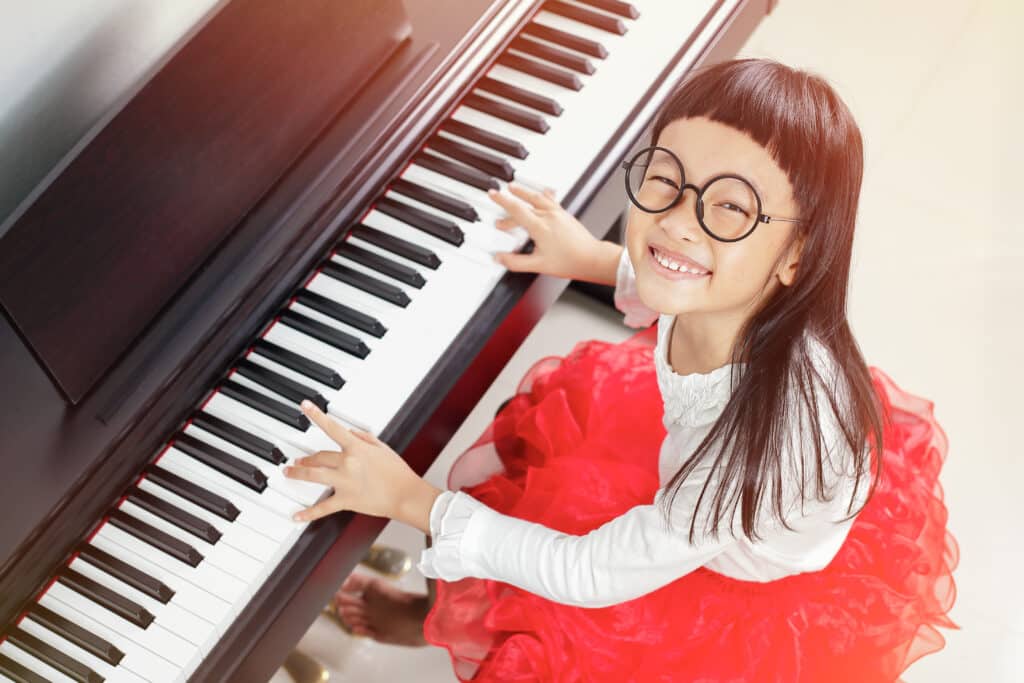 girl playing piano - performing arts