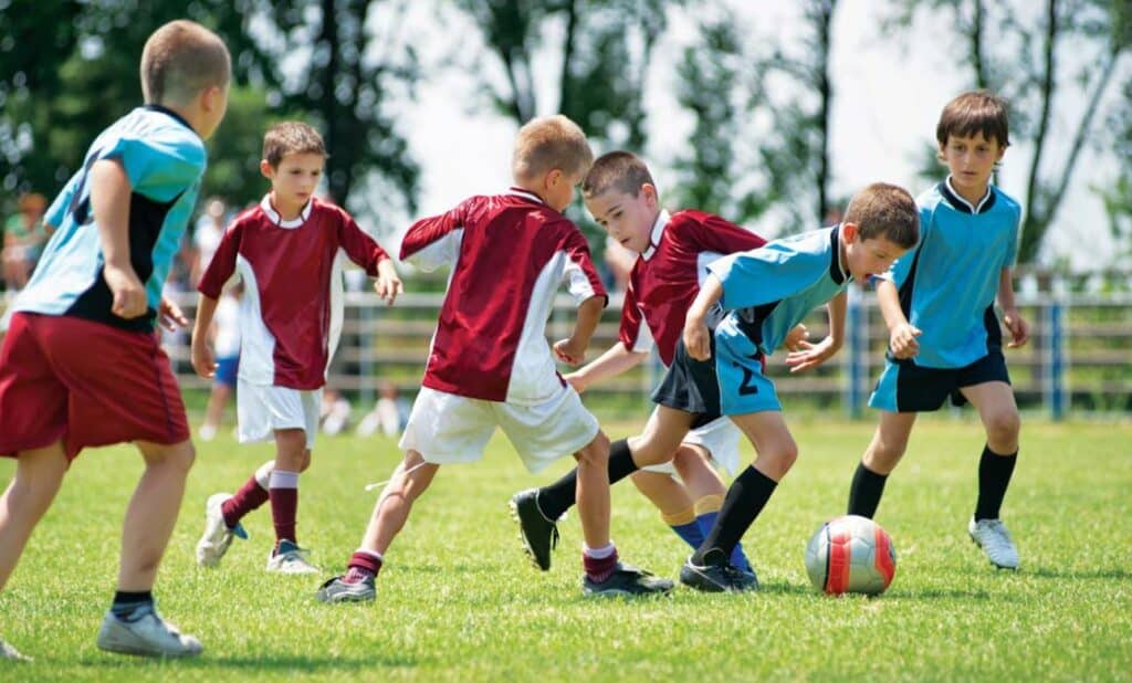 children playing soccer after school