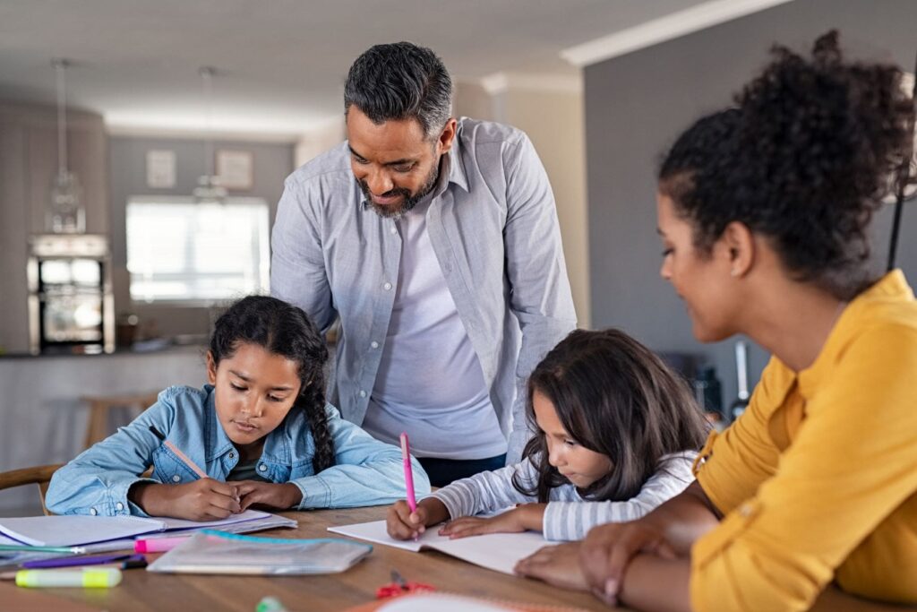 children getting help with school work from parents