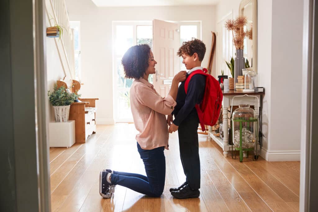 child preparing for school with mom