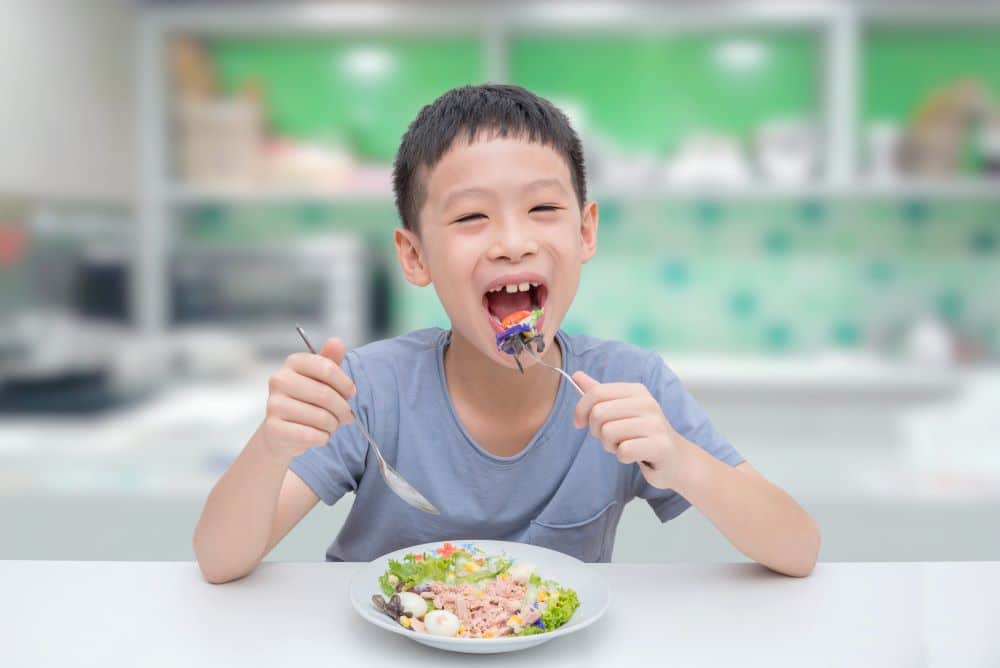 BOY EATING SALAD