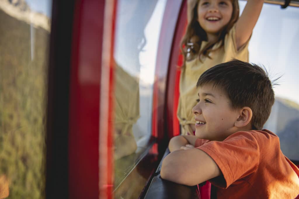 Kids enjoying a view of the mountain during their summer holiday