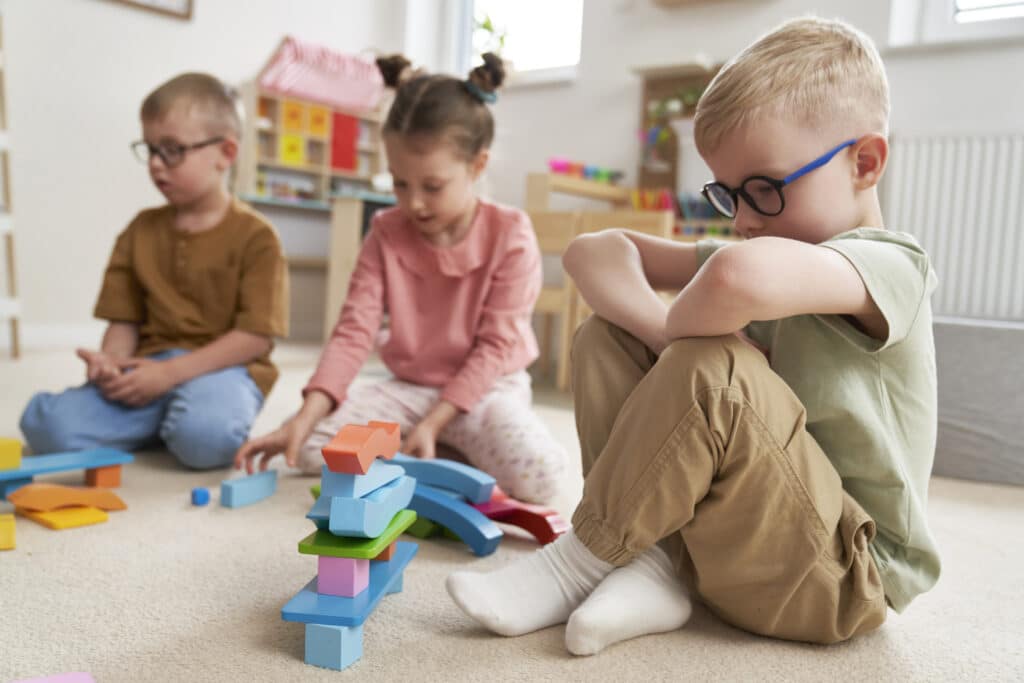 Summer activity - Children playing with toy blocks in the kindergarten