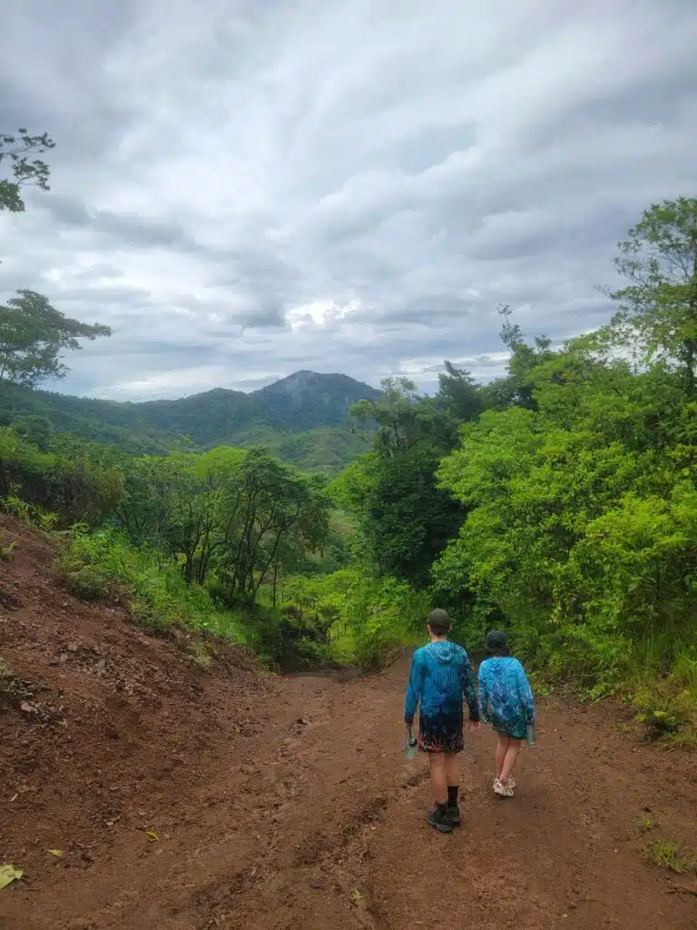 Boy and girl walking on a dirt road in Panama
