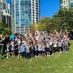 Claren Academy class posing on the grass near the school.