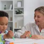 A neurodivergent child with a therapist.