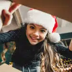 Tween girl opening a gift