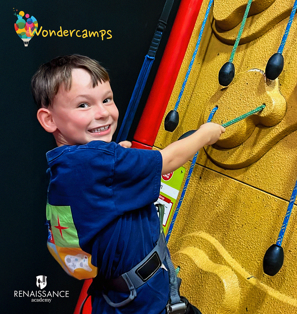 Boy Climbing at WonderCamps with logo