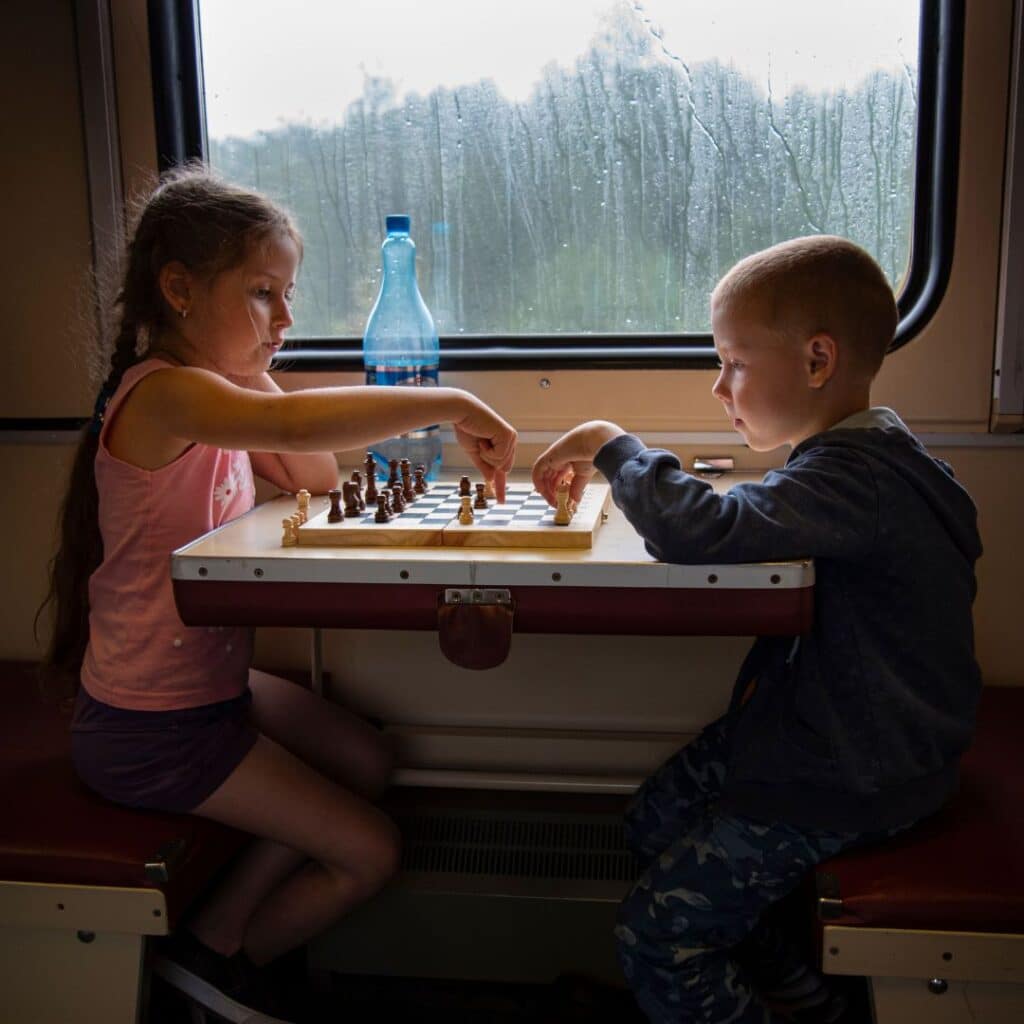 kids playing chess in the rainy weather