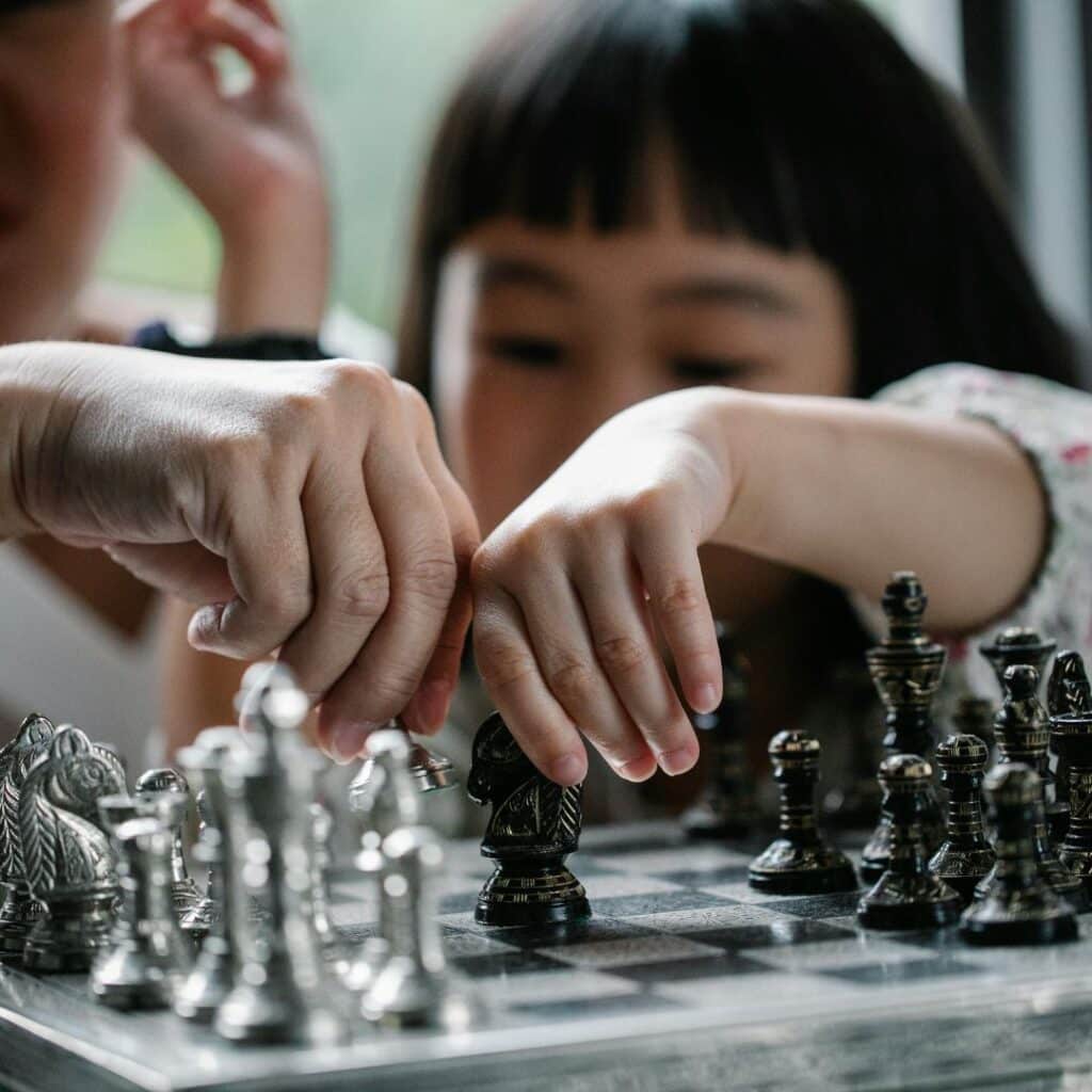 A little girl playing chess