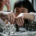A little girl playing chess
