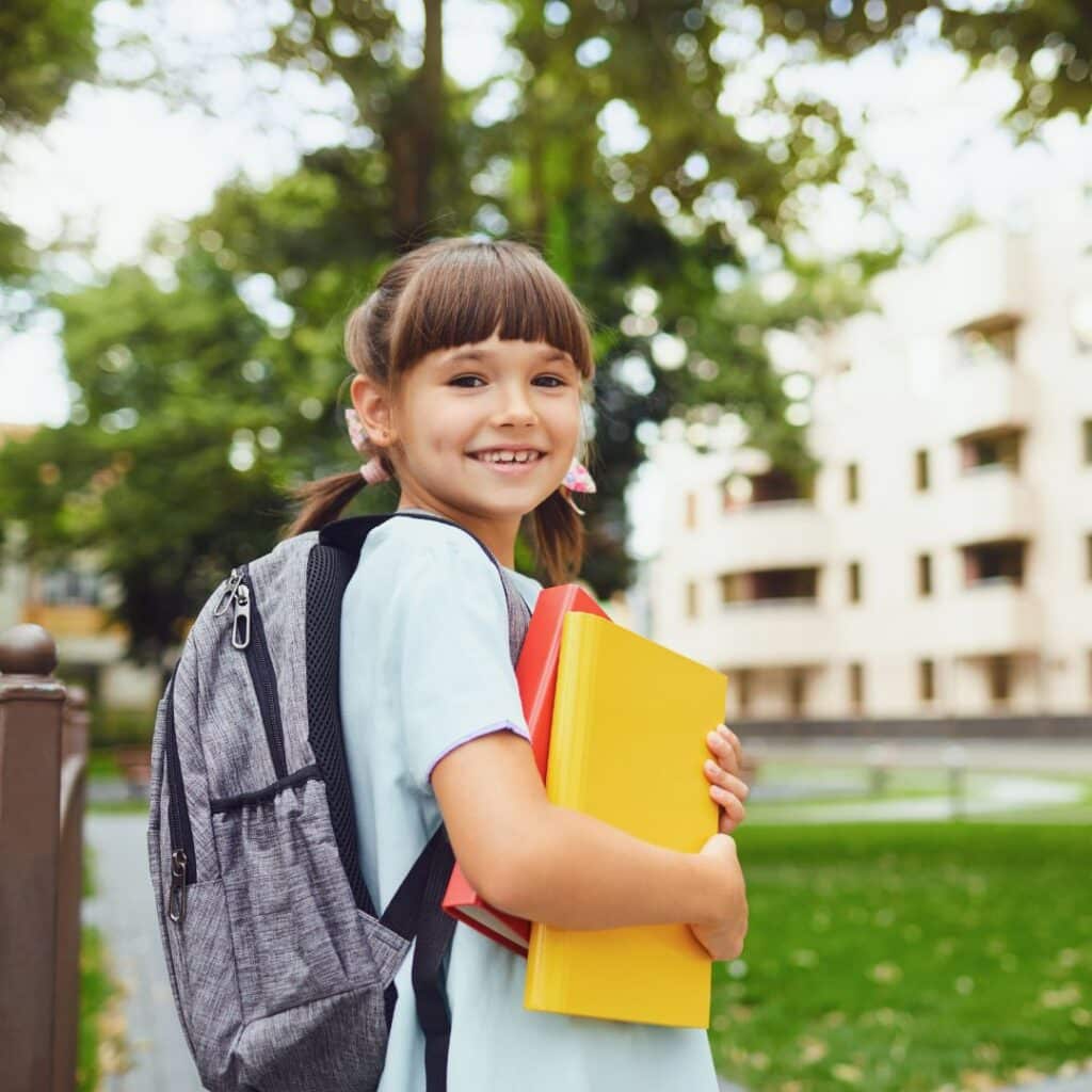 a girl going to school with a backpack