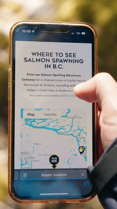 person holding open the app from Pacific Salmon Foundation 